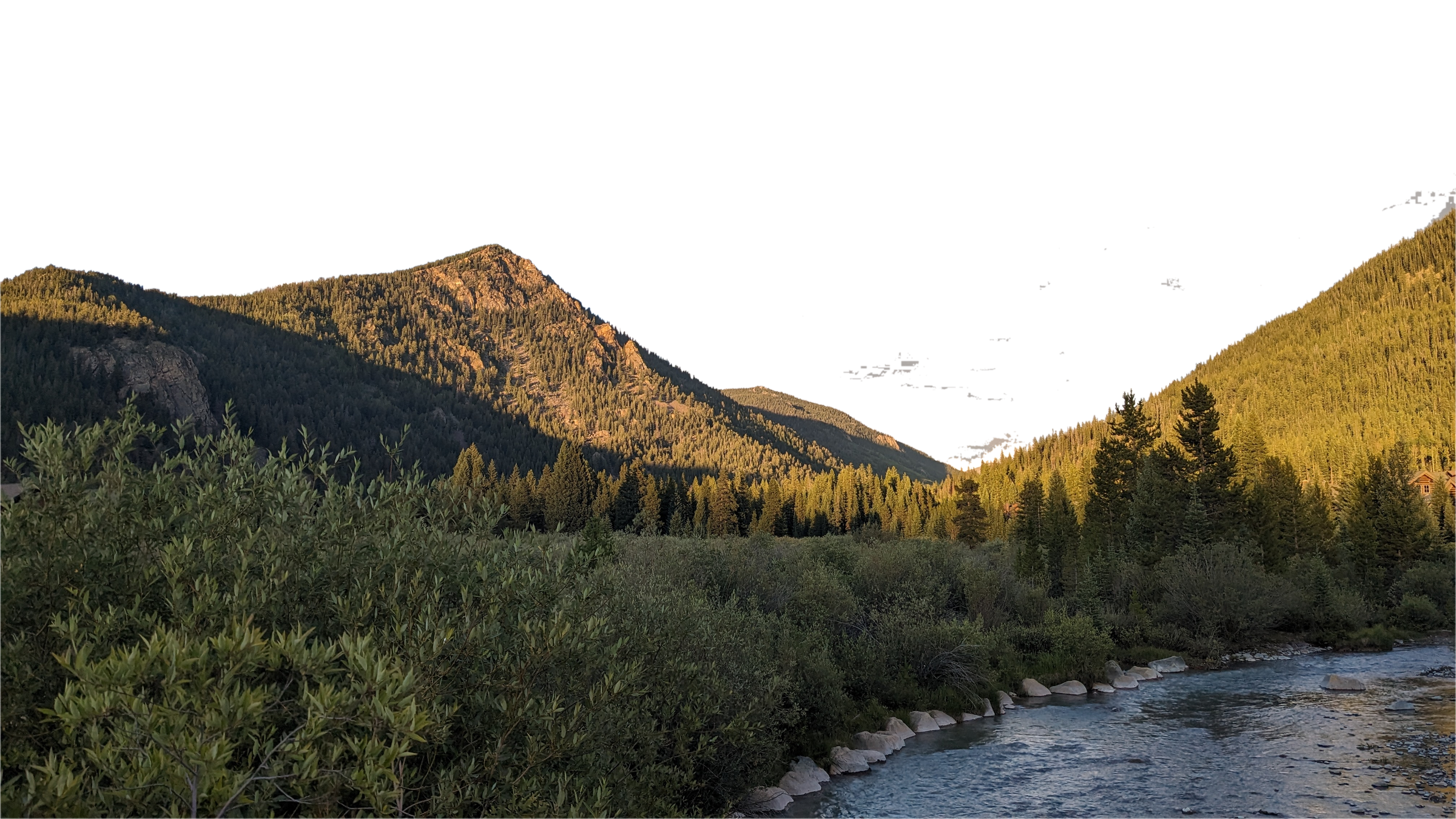 A mountain valley and river at golden hour in the Colorado Rockies